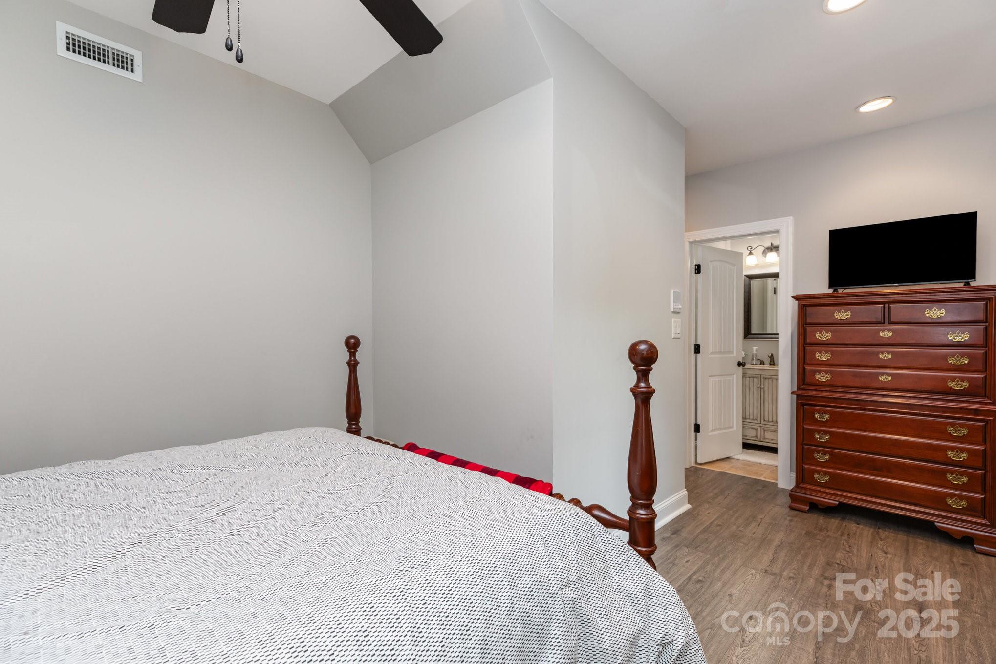 3351 Beulah Church Road Matthews, NC 28104 - Photo 29 of 33 a bedroom with a bed and a flat tv screen