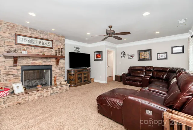 a living room with furniture a flat screen tv and a fireplace