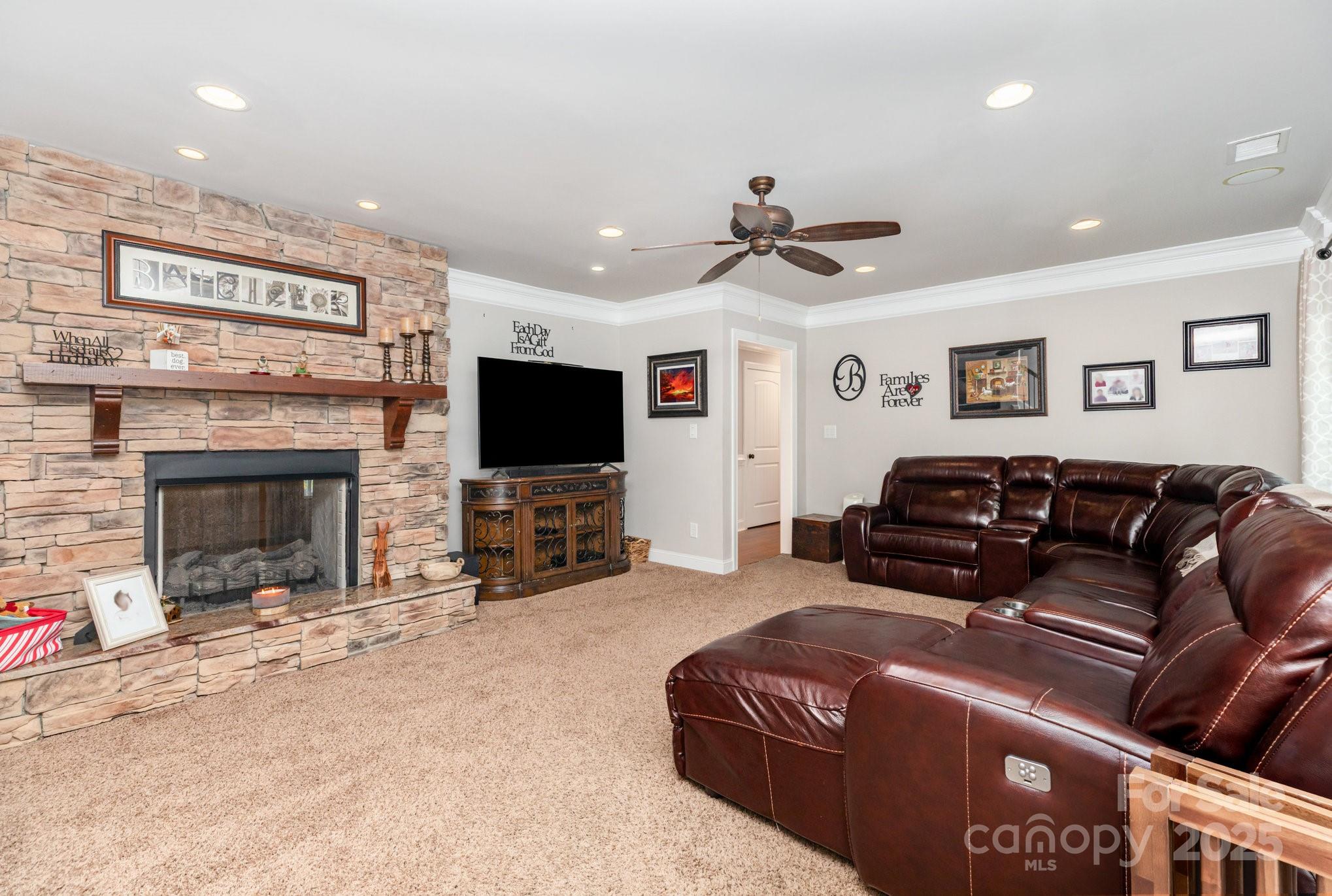 3351 Beulah Church Road Matthews, NC 28104 - Photo 3 of 33 a living room with furniture a flat screen tv and a fireplace