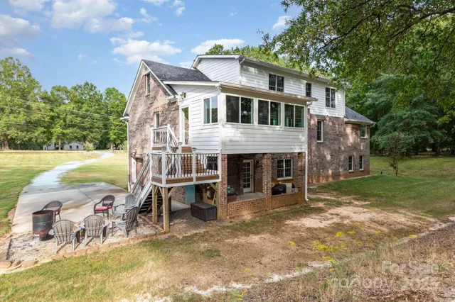a view of a house with backyard porch and sitting area