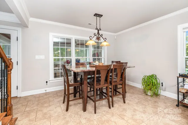 a view of a dining room with furniture and window