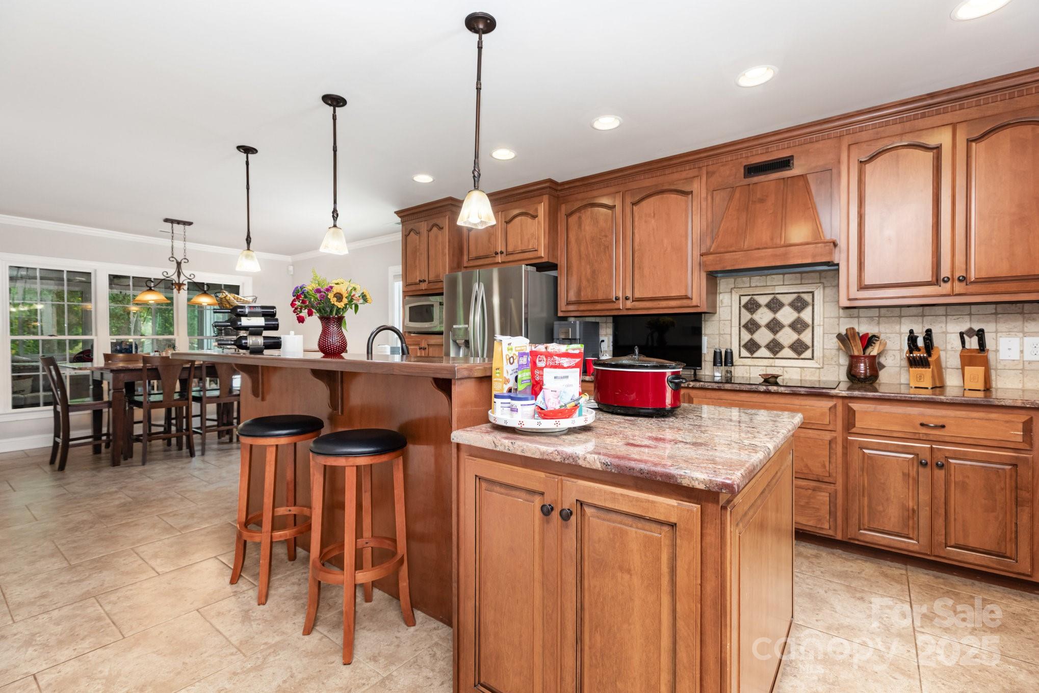 3351 Beulah Church Road Matthews, NC 28104 - Photo 8 of 33 a kitchen with stainless steel appliances granite countertop dining table chairs sink and cabinets