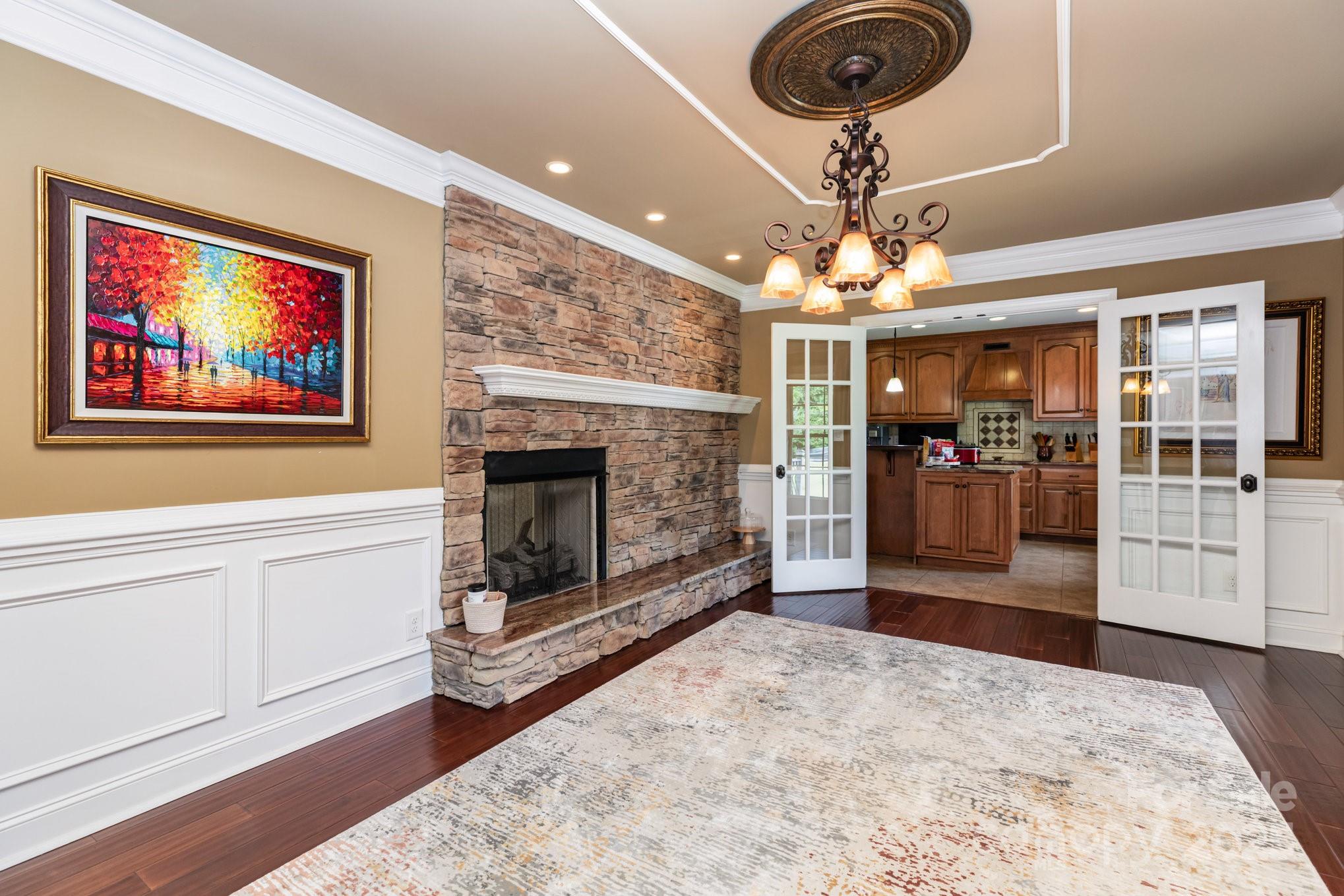 3351 Beulah Church Road Matthews, NC 28104 - Photo 10 of 33 a living room with furniture a fireplace and a chandelier