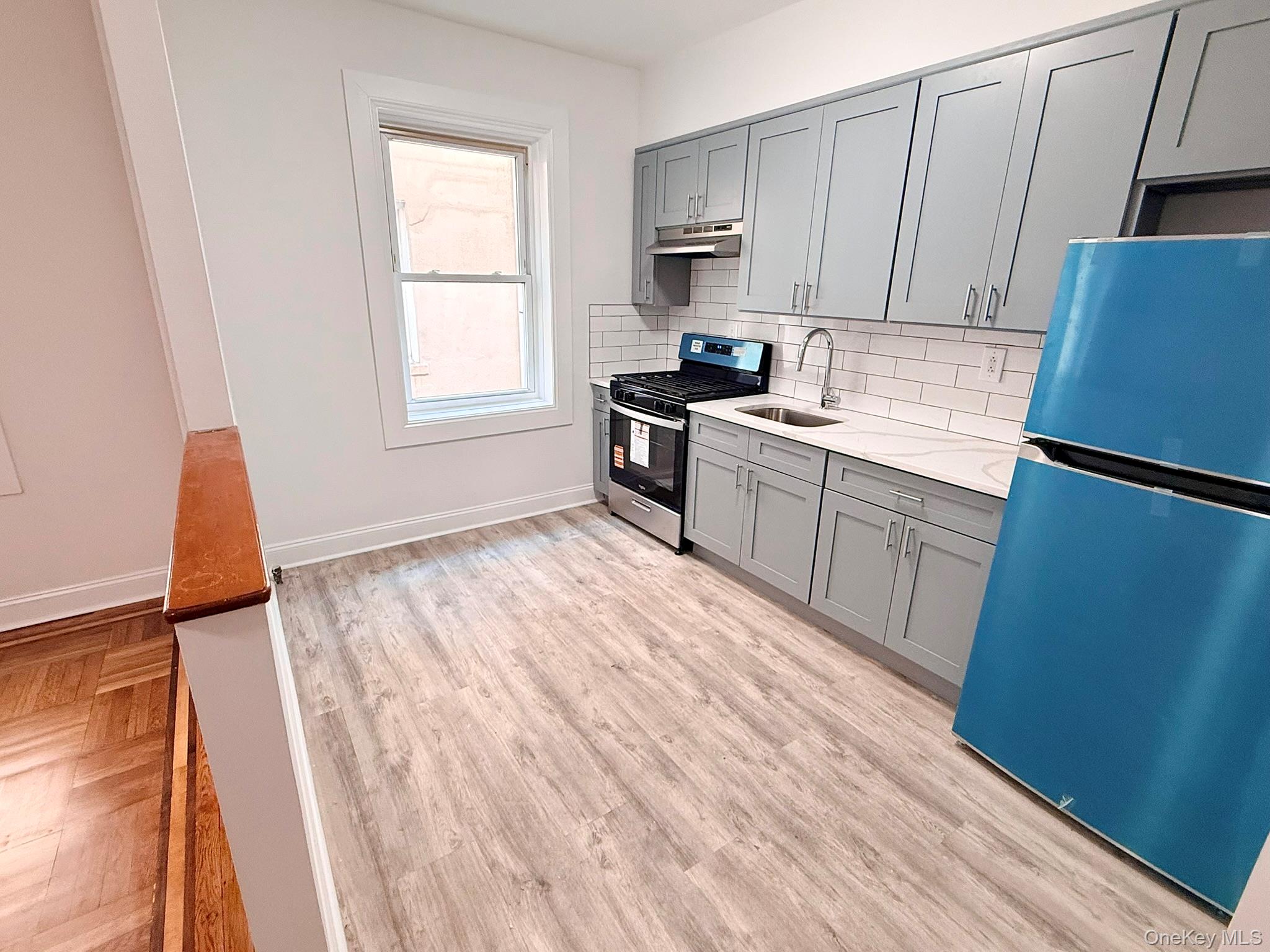 a kitchen with wooden floors and white appliances