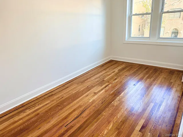 a view of a room with wooden floor and windows