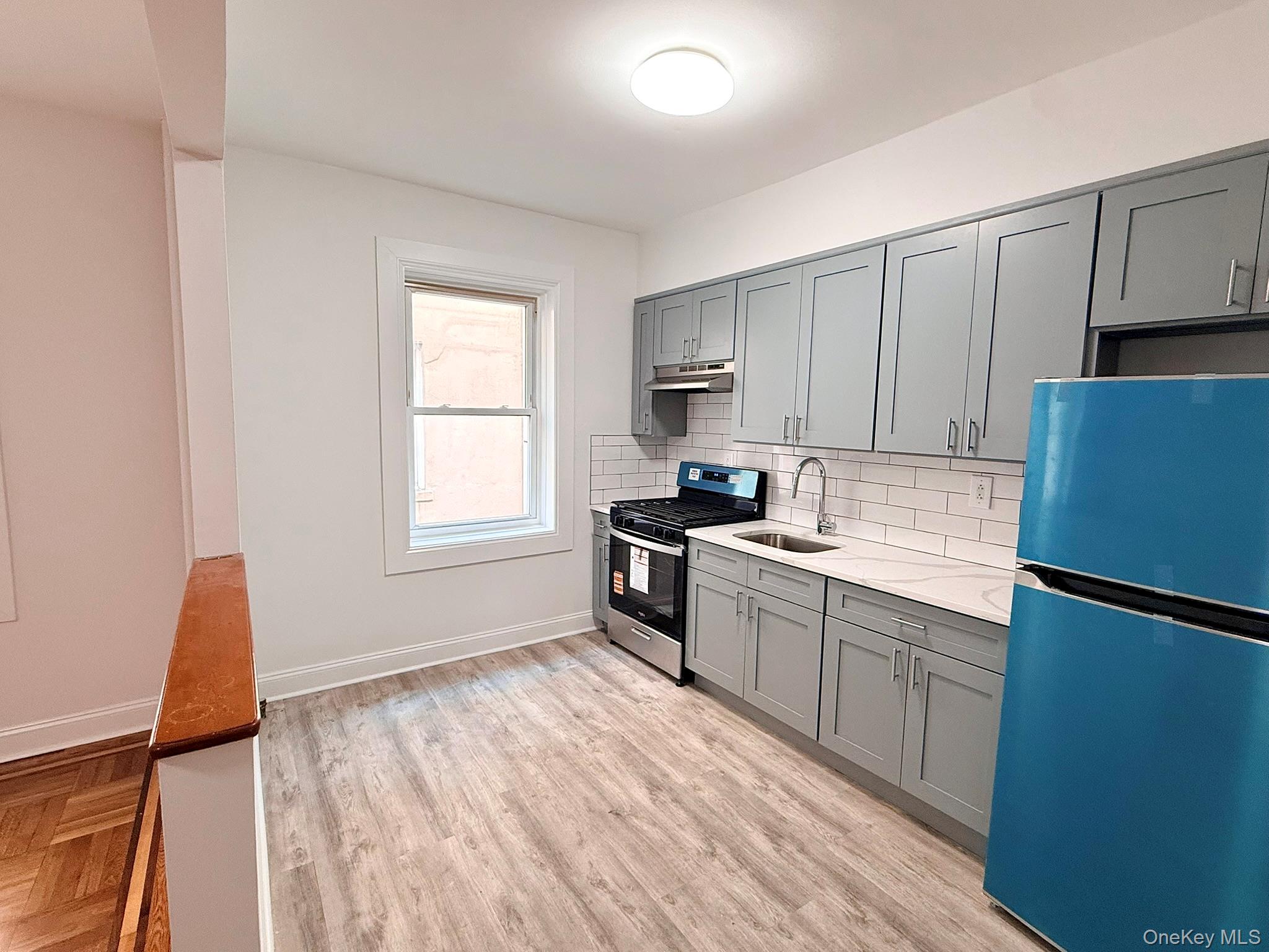 47-48 43rd Street, Unit 2F Queens, NY 11377 - Photo 2 of 29 a kitchen with granite countertop a refrigerator stove top oven and sink