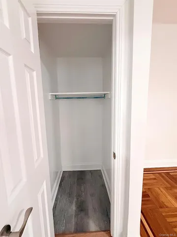 a view of walk in closet with clothes