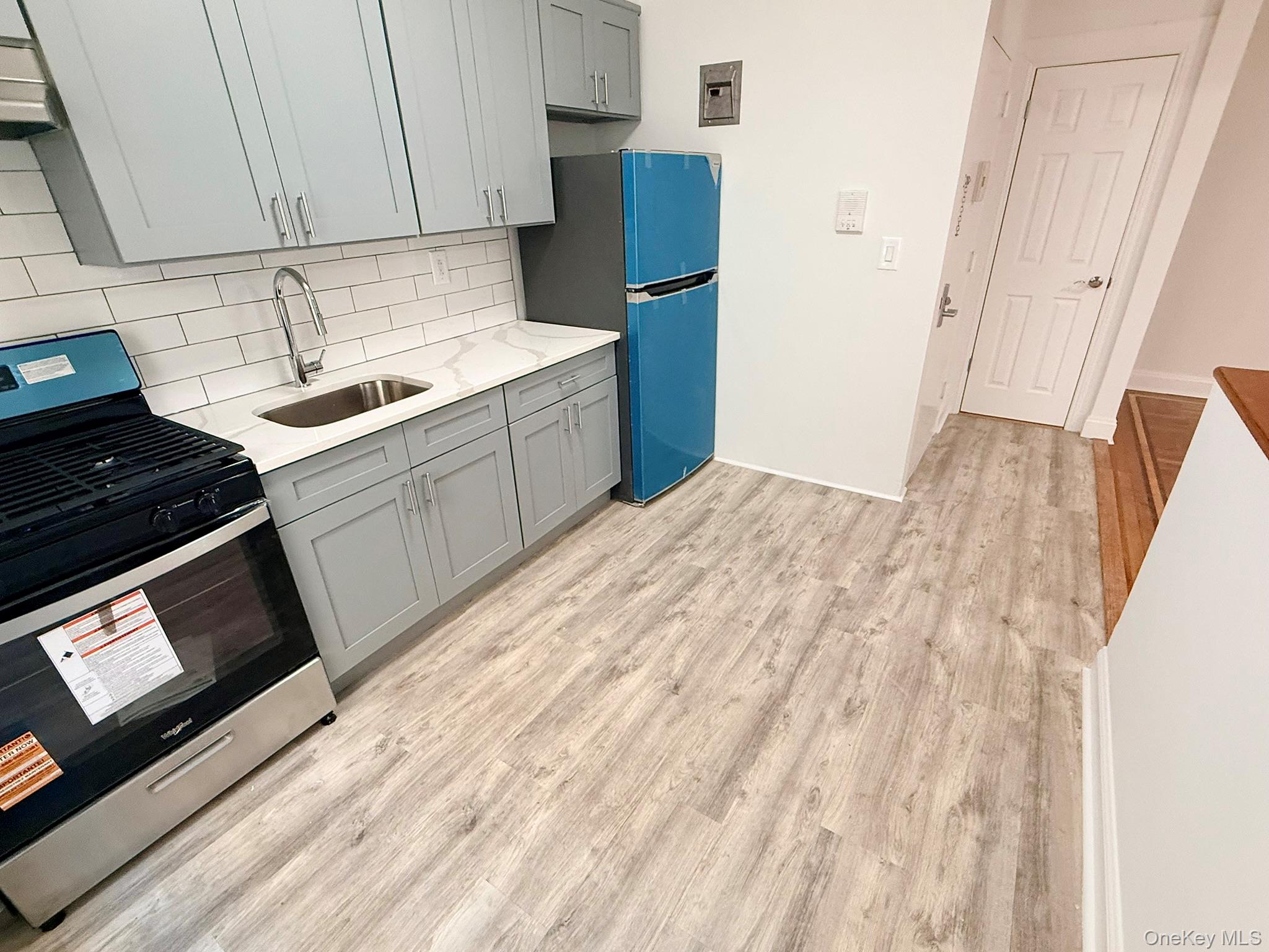 47-48 43rd Street, Unit 2F Queens, NY 11377 - Photo 3 of 29 a kitchen with a sink stove and cabinets