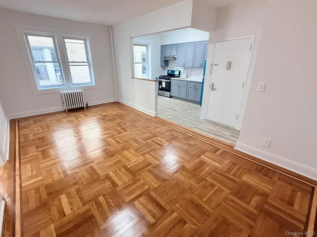 a view of a kitchen with wooden floor and a kitchen