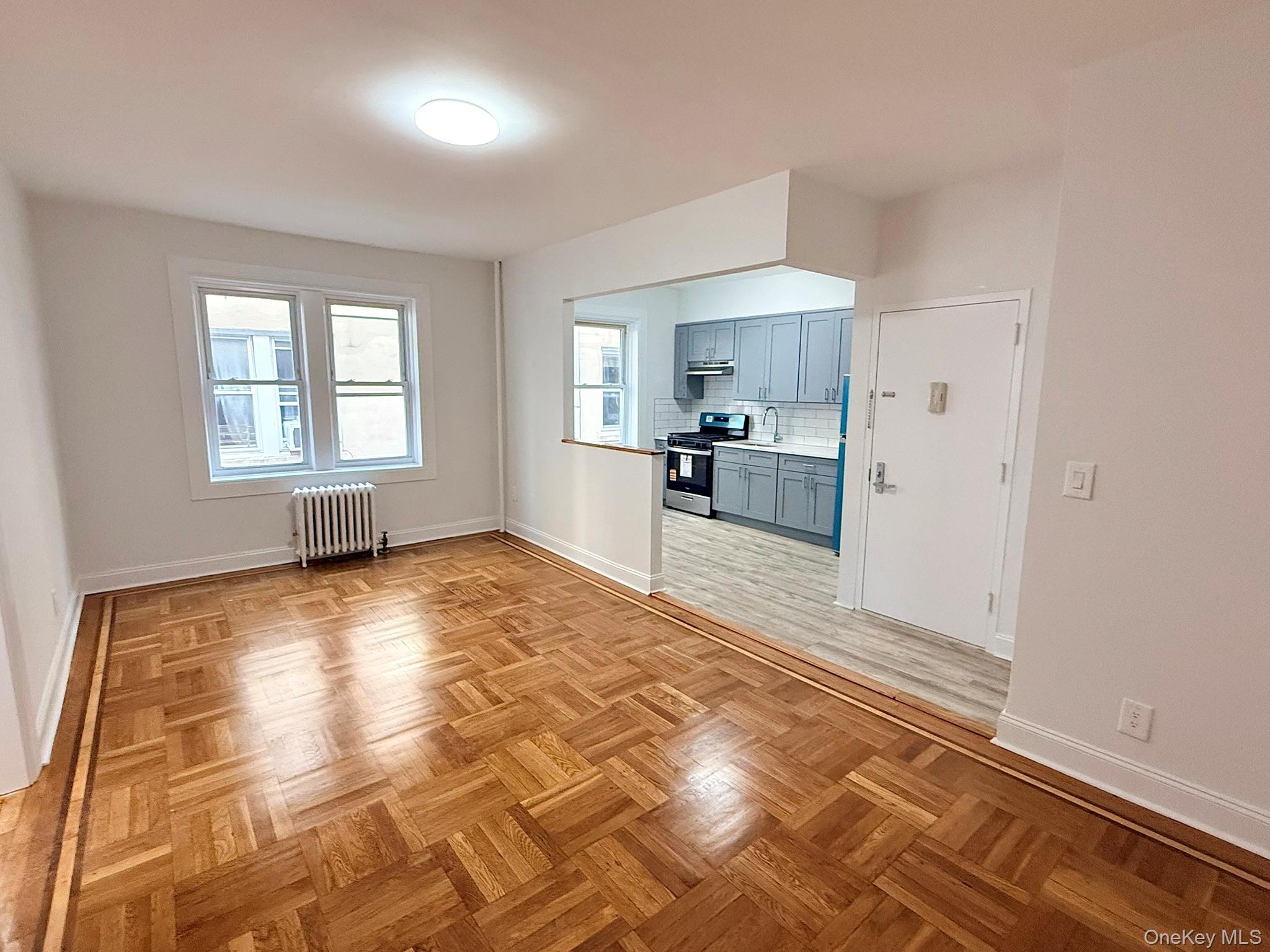 47-48 43rd Street, Unit 2F Queens, NY 11377 - Photo 7 of 29 a view of a kitchen with a sink and cabinets