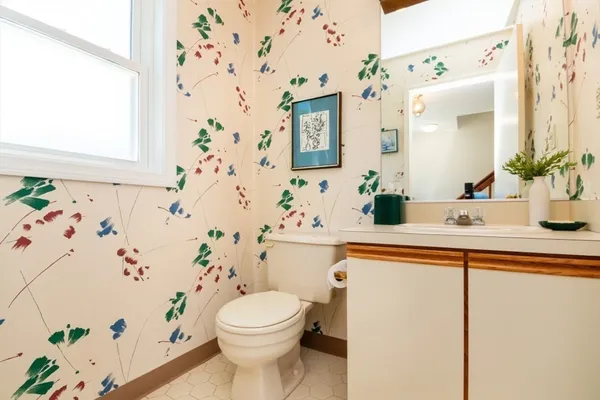 a bathroom with a sink a toilet and a shower curtain