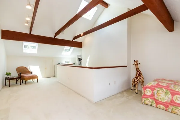 a bedroom with furniture and a window