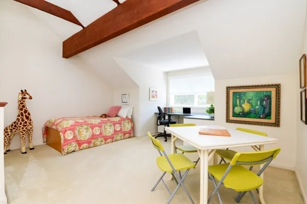 a bedroom with a bed and a table in it