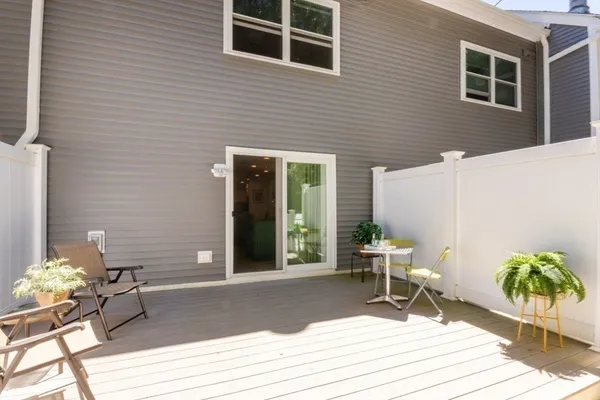a building outdoor space with patio furniture and potted plants