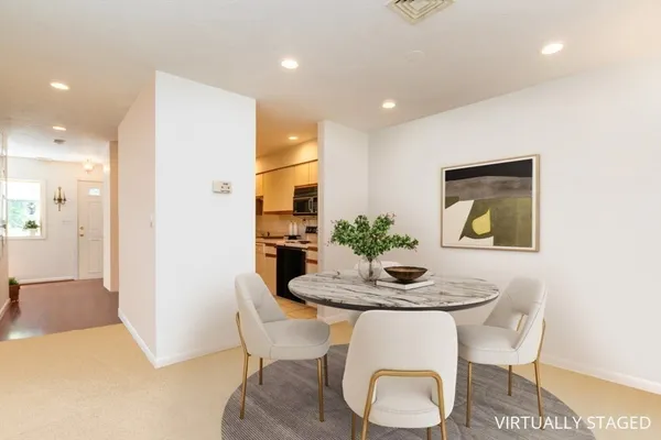 a dining room with furniture and window
