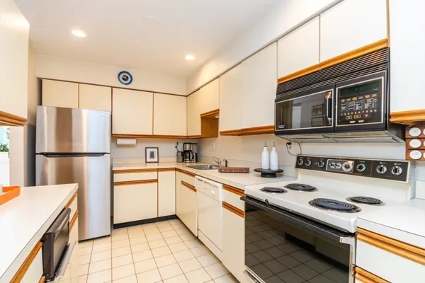 a kitchen with a sink a stove and refrigerator