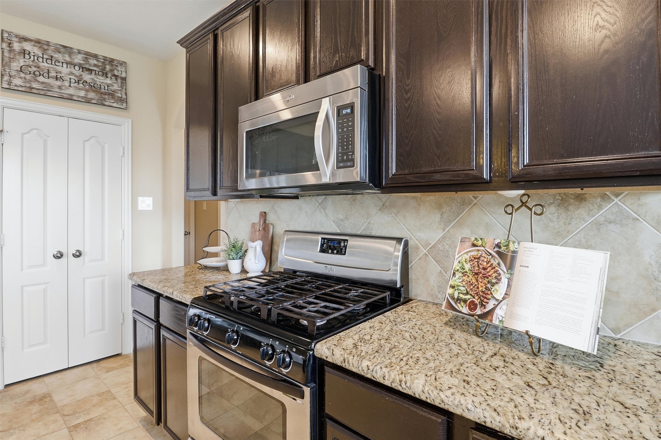 3219 Cotton Ranch Drive Katy, TX 77494 - Photo 12 of 45 The stainless steel gas range, built-in microwave, and durable granite countertops create a kitchen that's ready for everything from weeknight dinners to holiday gatherings.