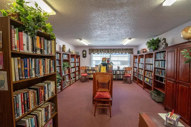 a room with lots of furniture and a book shelf