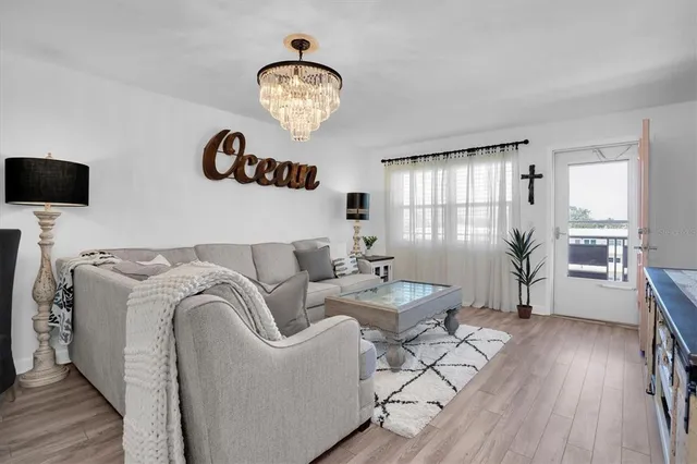 a living room with furniture a window and wooden floor