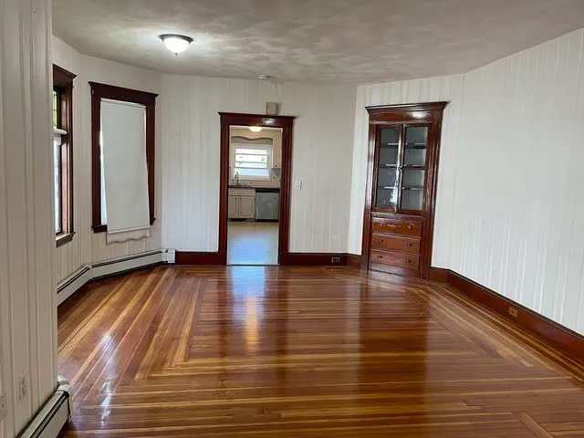 an empty room with wooden floor and closet
