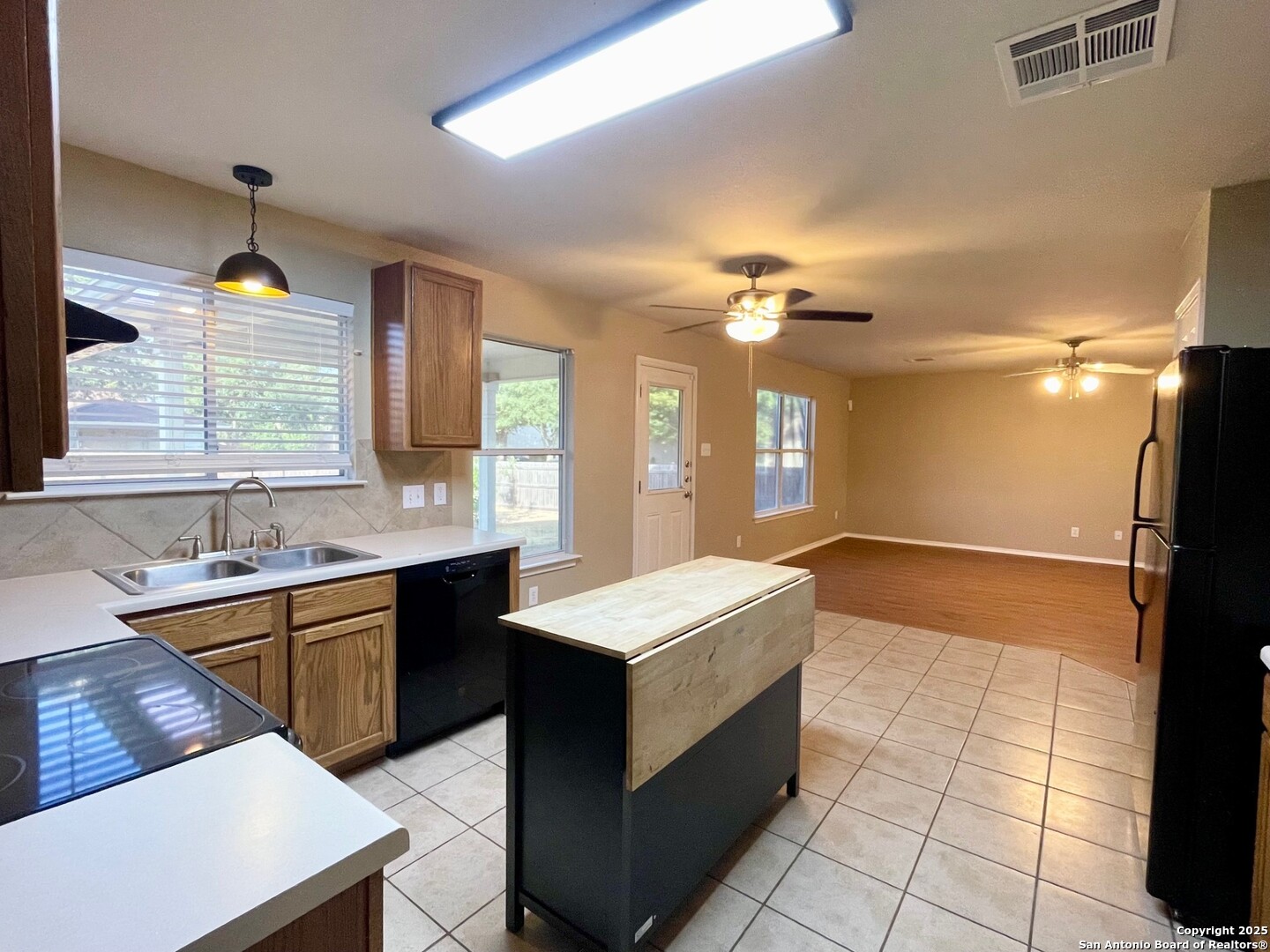 145 Pinto Place Cibolo, TX 78108 - Photo 14 of 32 a large kitchen with kitchen island a sink stainless steel appliances and cabinets