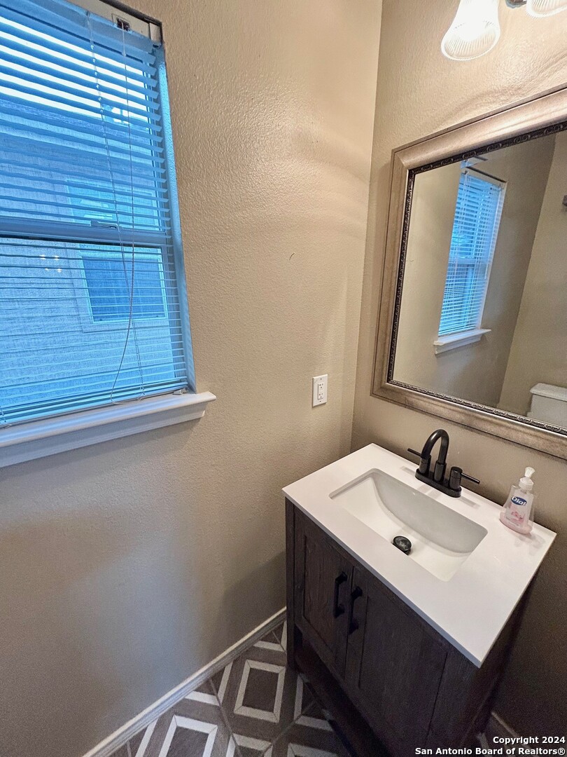 145 Pinto Place Cibolo, TX 78108 - Photo 18 of 32 a bathroom with a sink vanity and a mirror