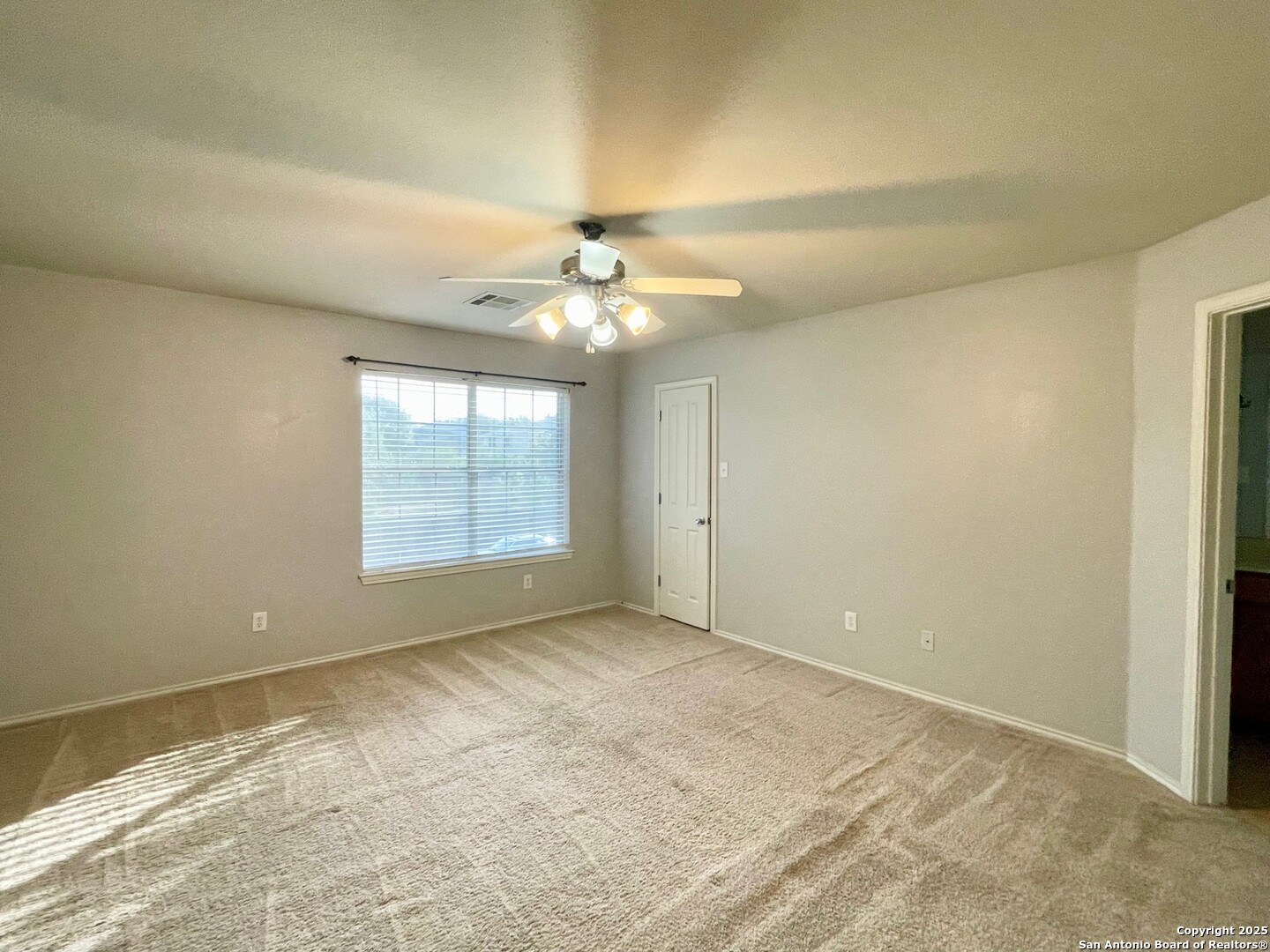 145 Pinto Place Cibolo, TX 78108 - Photo 19 of 32 en empty room with windows and chandelier fan