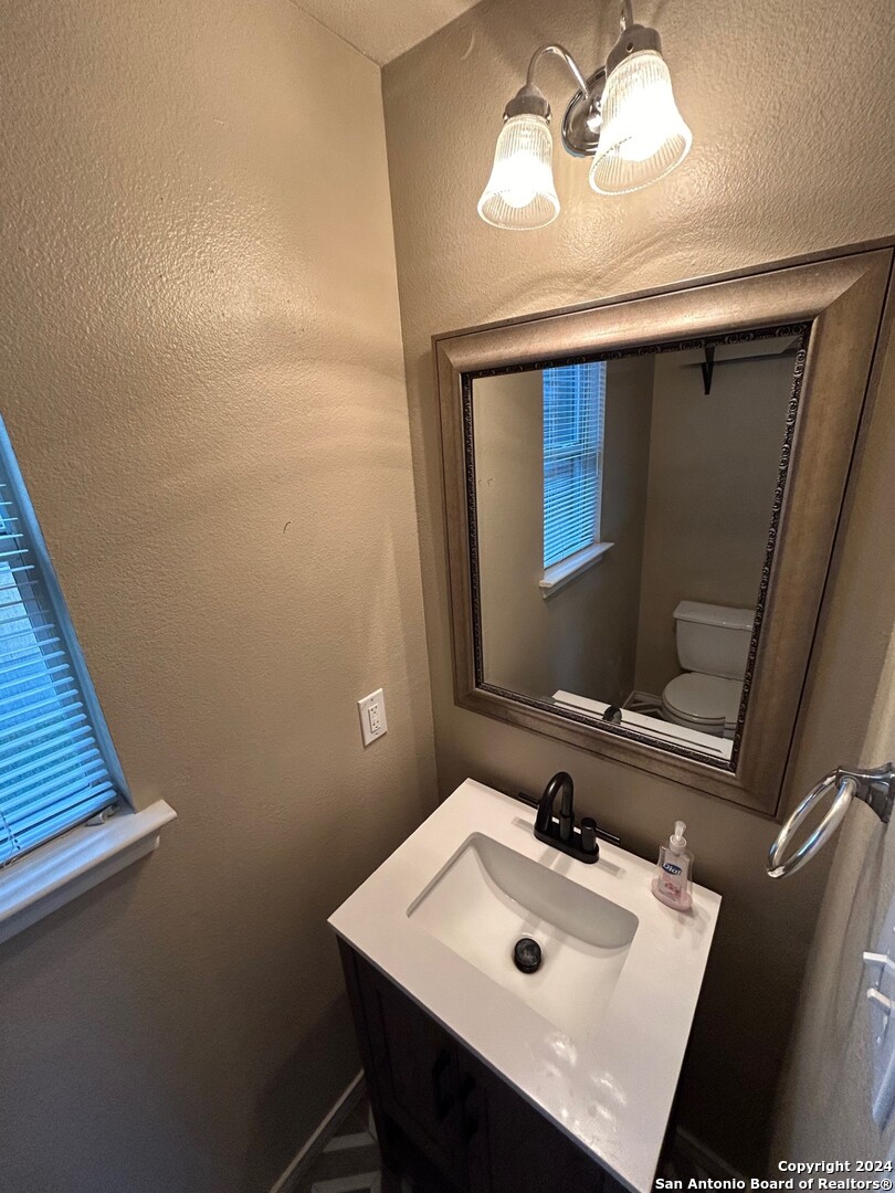 145 Pinto Place Cibolo, TX 78108 - Photo 23 of 32 a bathroom with a sink a mirror and vanity