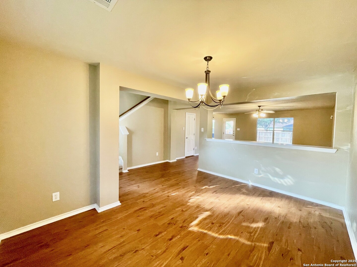 145 Pinto Place Cibolo, TX 78108 - Photo 8 of 32 a view of an empty room with wooden floor and a window