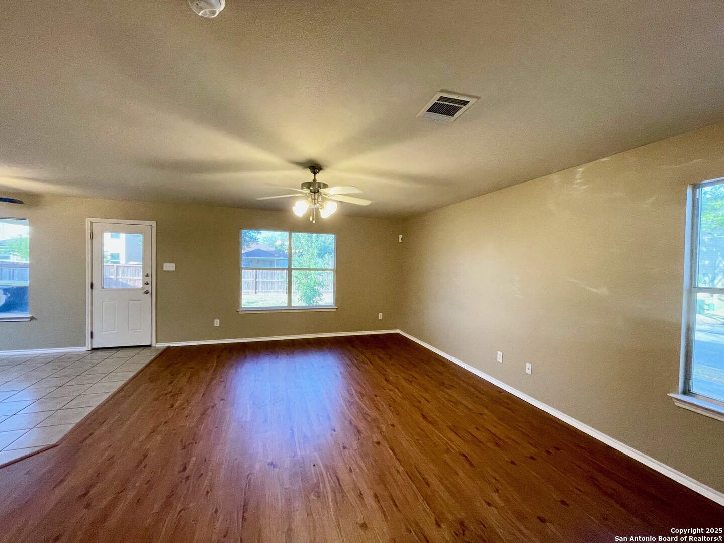 145 Pinto Place Cibolo, TX 78108 - Photo 10 of 32 a view of an empty room with wooden floor and a window