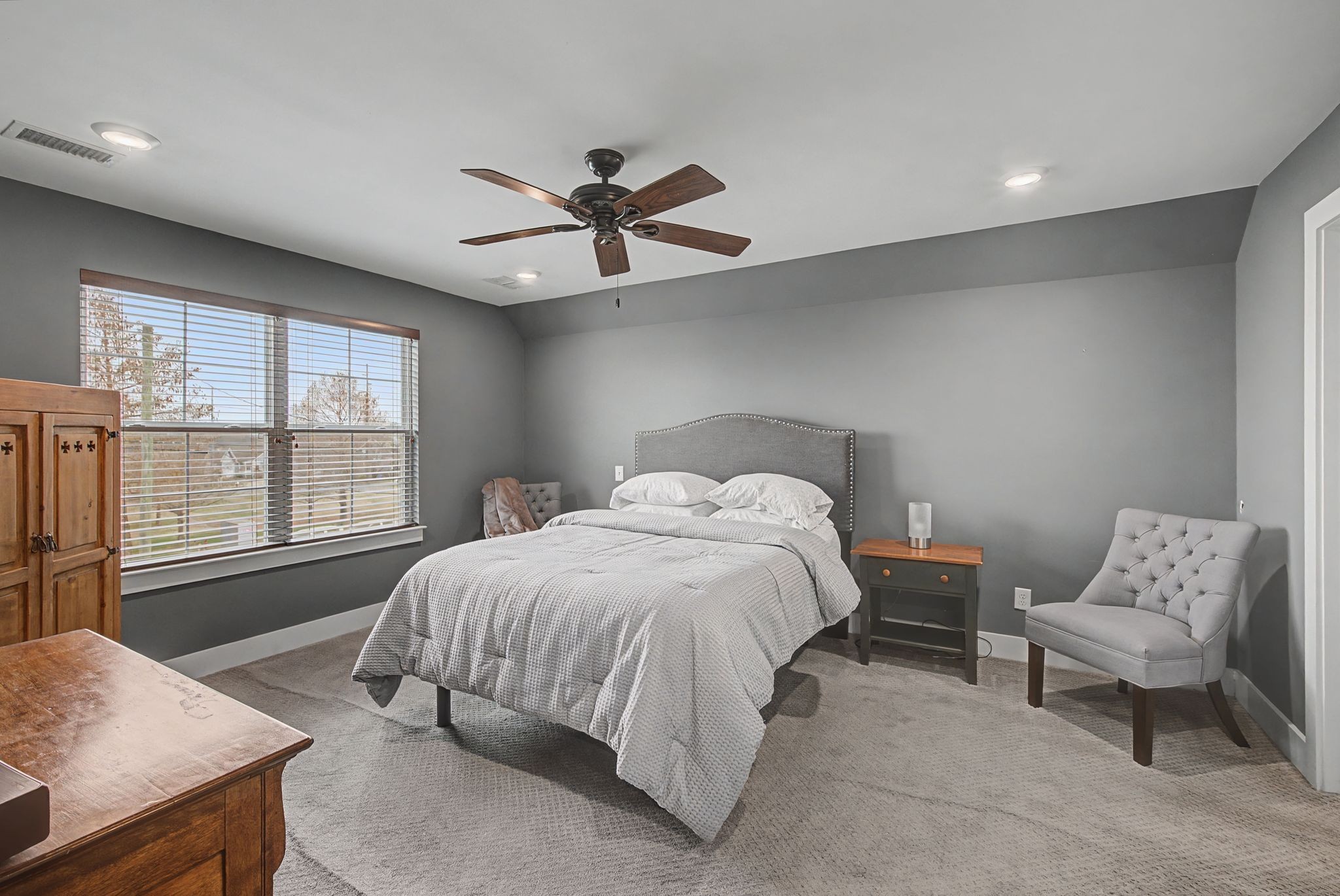 420 Anderson Lane Madison, TN 37115 - Photo 19 of 28 a spacious bedroom with a bed a couch and a window