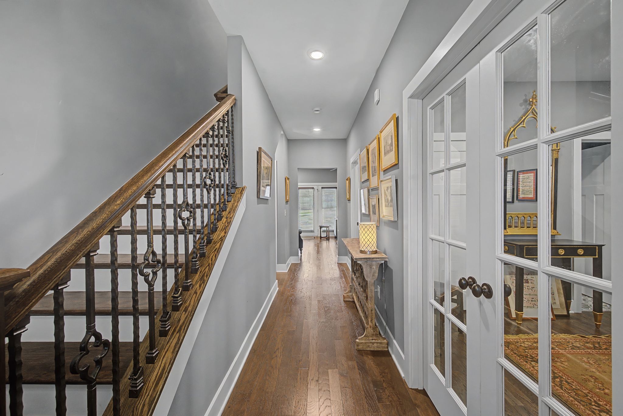 420 Anderson Lane Madison, TN 37115 - Photo 2 of 28 a view of staircase with lots of frames on wall and wooden floor