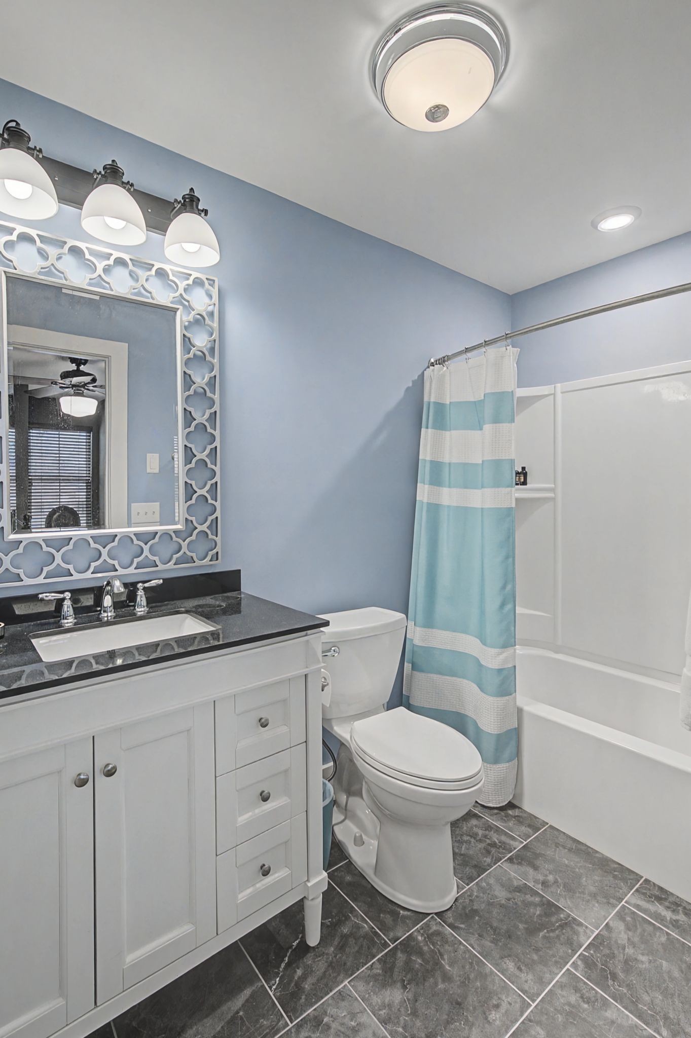 420 Anderson Lane Madison, TN 37115 - Photo 24 of 28 a bathroom with a granite countertop toilet a sink and a mirror