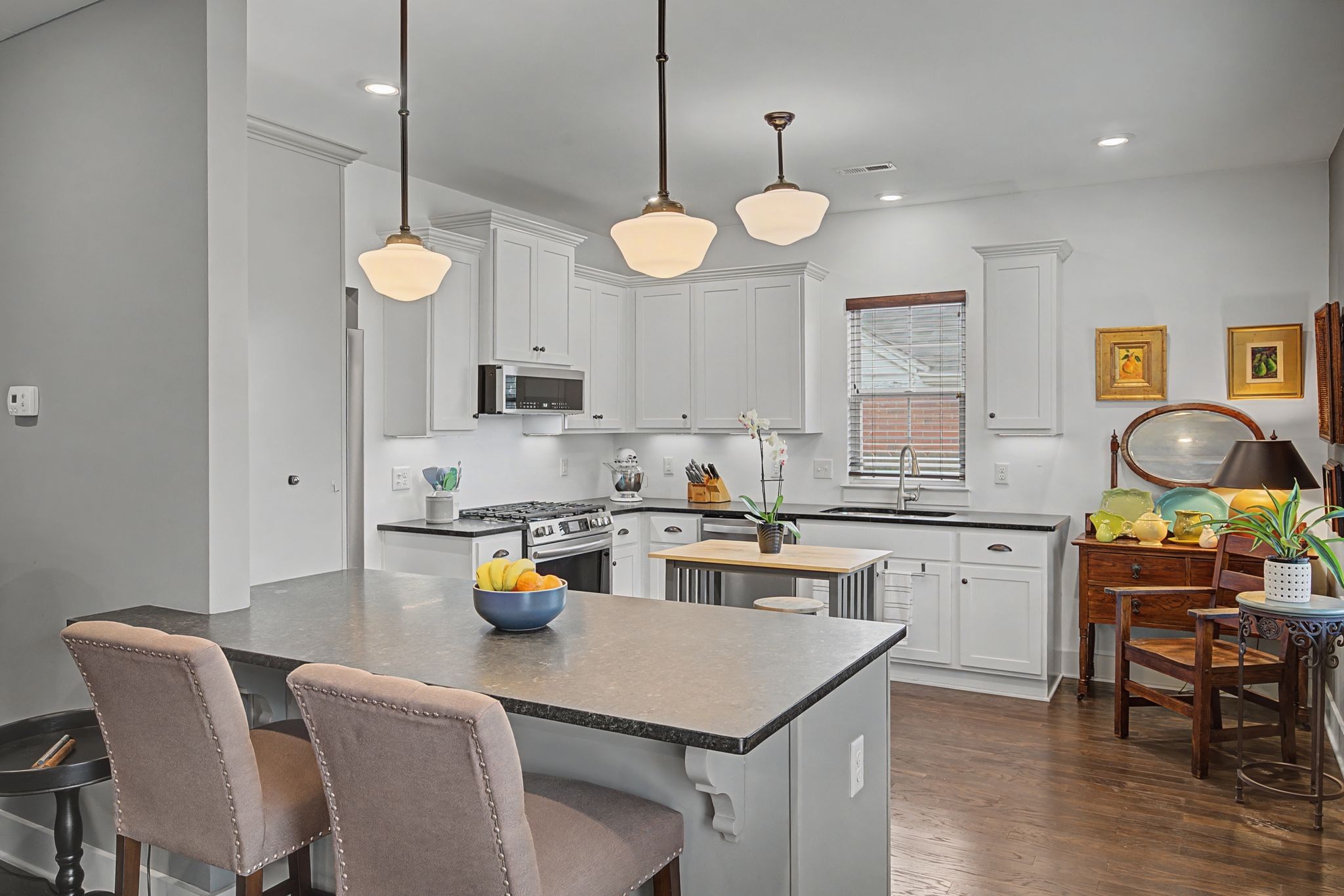 420 Anderson Lane Madison, TN 37115 - Photo 10 of 28 a kitchen with a dining table a stove cabinets and wooden floor