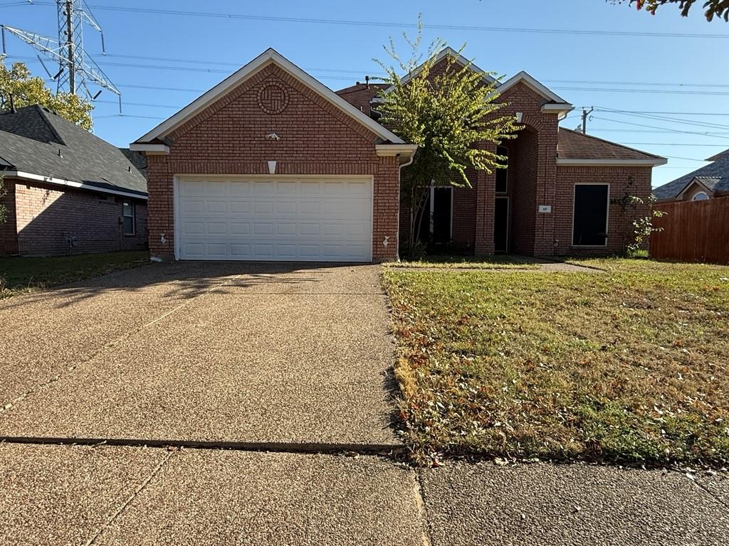 117 Hanover Street Grand Prairie, TX 75052 - Photo 1 of 40 a front view of a house with a yard and garage