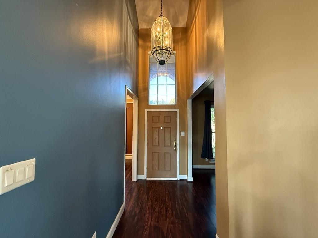 117 Hanover Street Grand Prairie, TX 75052 - Photo 11 of 40 a view of a hallway with wooden floor and a cabinet