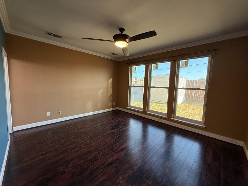 117 Hanover Street Grand Prairie, TX 75052 - Photo 13 of 40 a view of empty room with wooden floor and fan