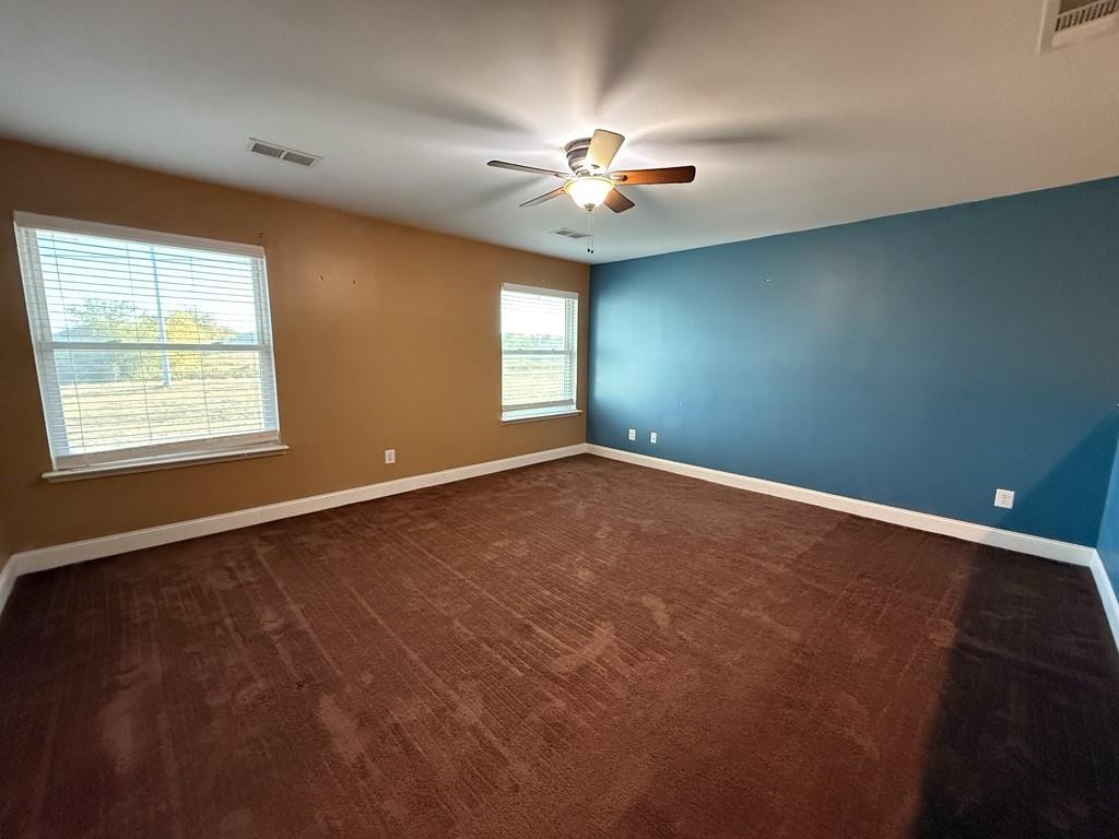 117 Hanover Street Grand Prairie, TX 75052 - Photo 26 of 40 an empty room with windows and fan