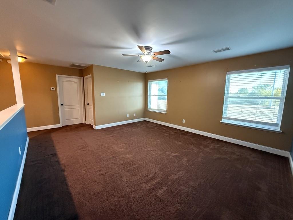 117 Hanover Street Grand Prairie, TX 75052 - Photo 29 of 40 an empty room with windows and fan