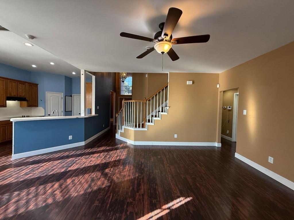 117 Hanover Street Grand Prairie, TX 75052 - Photo 3 of 40 a view of a livingroom with a kitchen counter tops and wooden floor