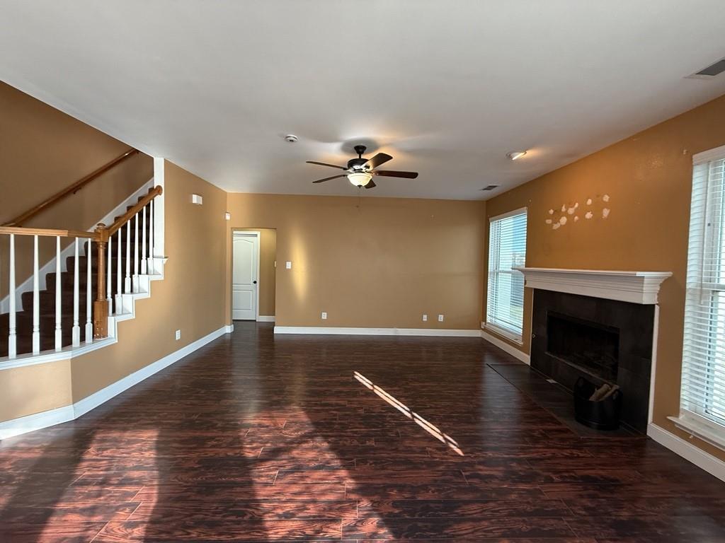 117 Hanover Street Grand Prairie, TX 75052 - Photo 4 of 40 a view of an empty room with wooden floor fireplace and a window