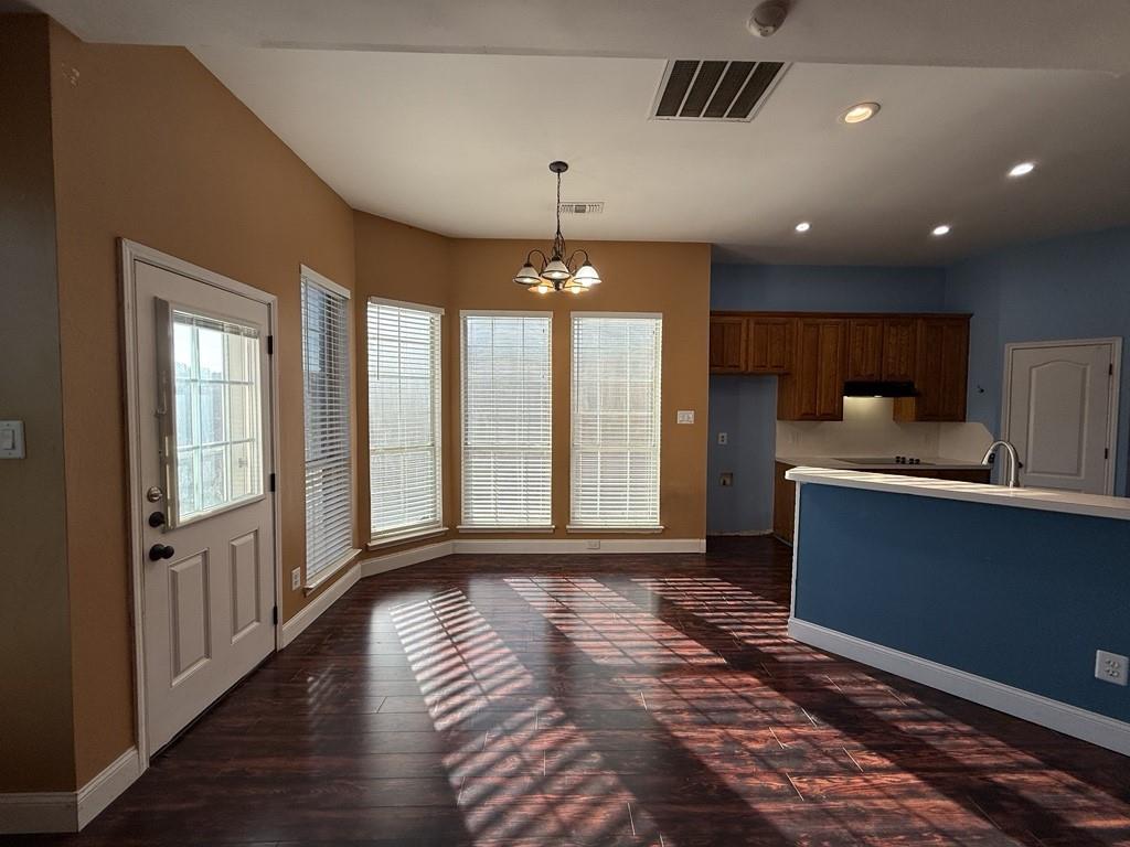117 Hanover Street Grand Prairie, TX 75052 - Photo 5 of 40 a view of entryway and kitchen with a sink wooden floor and windows