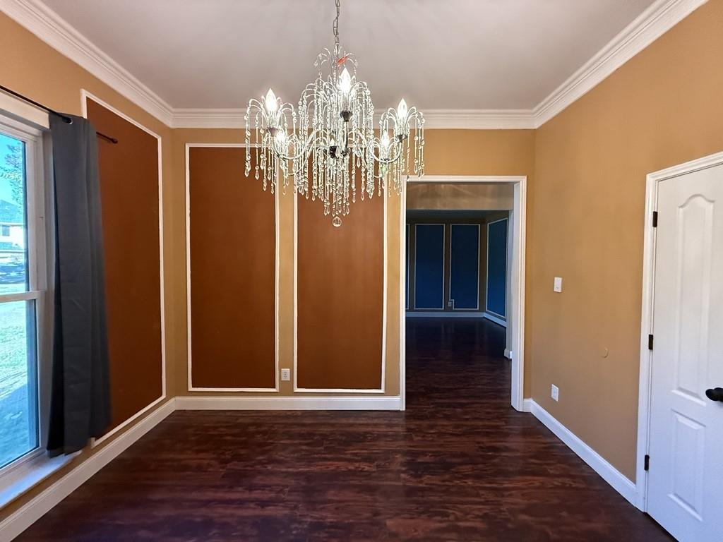 117 Hanover Street Grand Prairie, TX 75052 - Photo 9 of 40 wooden floor in an empty room with kitchen and windows
