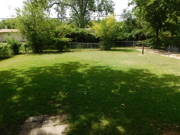 a view of a swimming pool with a yard