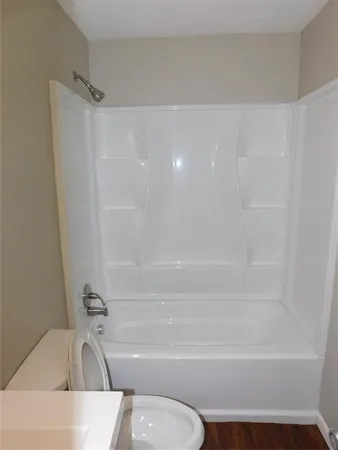 a bathroom with a shower and a bathtub