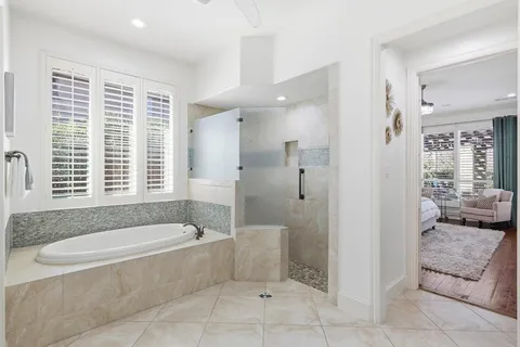 a spacious bathroom with a granite countertop tub shower and sink