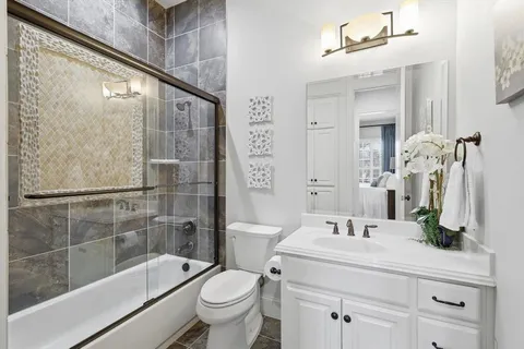 a bathroom with a sink mirror toilet and bathtub