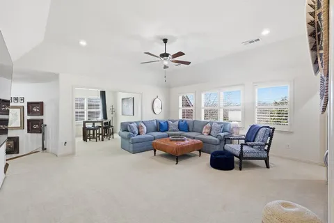 a living room with furniture and large windows