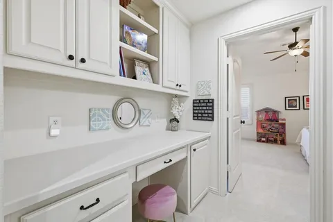 a utility room with cabinets and a wooden floor
