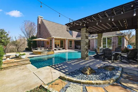 a view of a house with backyard porch and sitting area